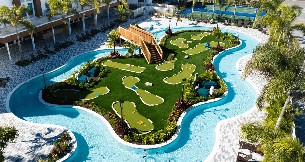 Aerial view of a resort pool with a putting green in the center