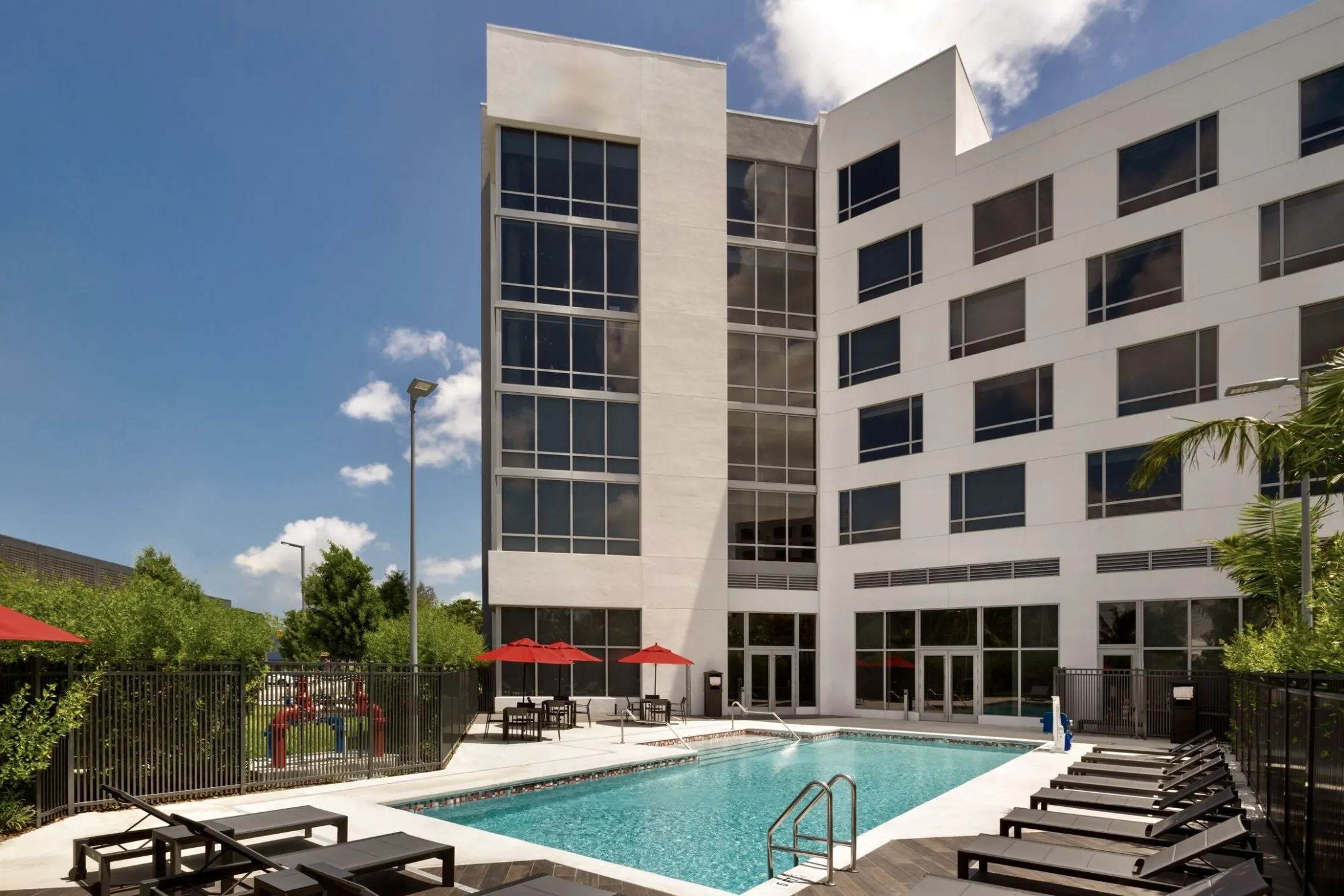 A hotel exterior with a pool area