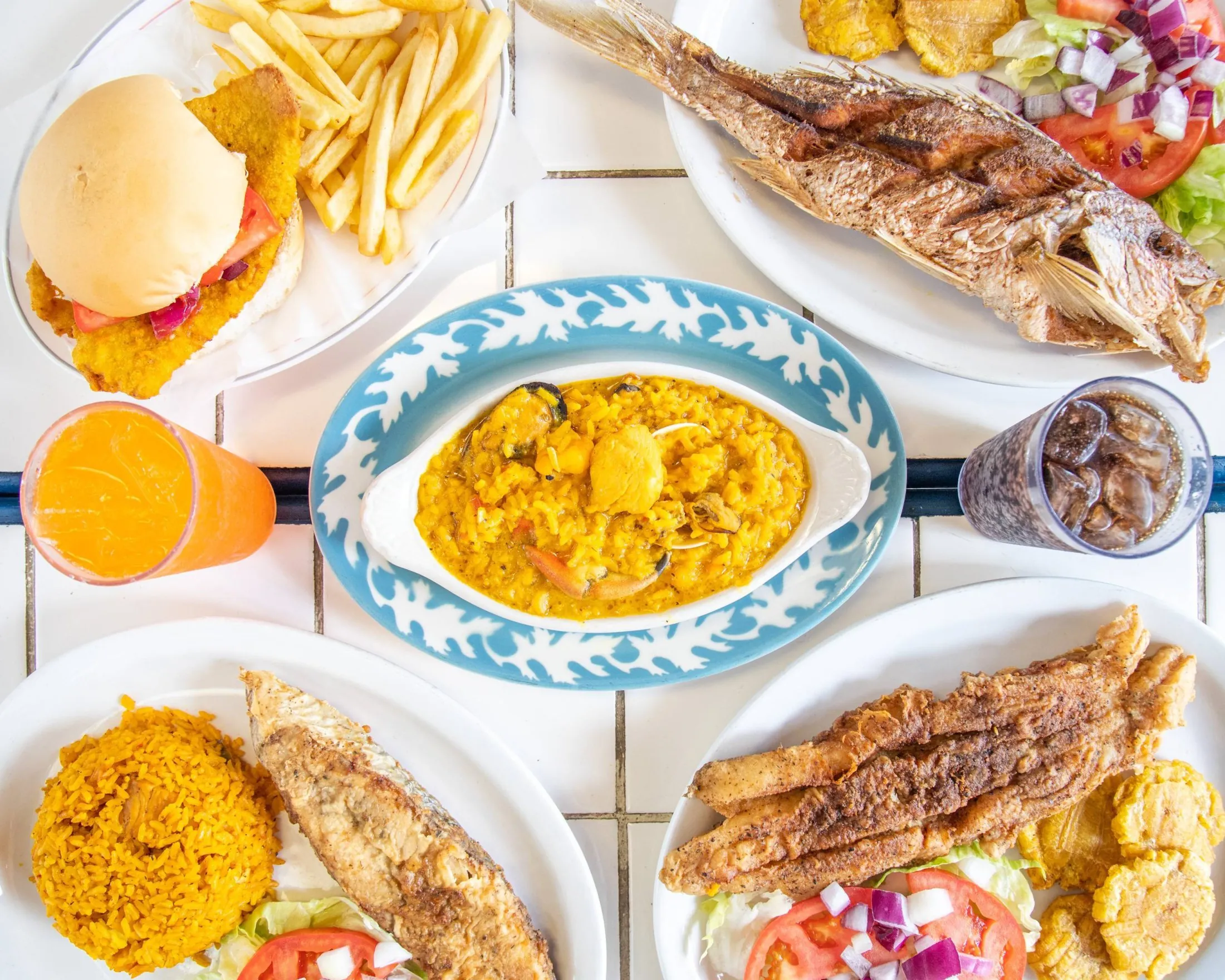 A table with various plates of food and drinks